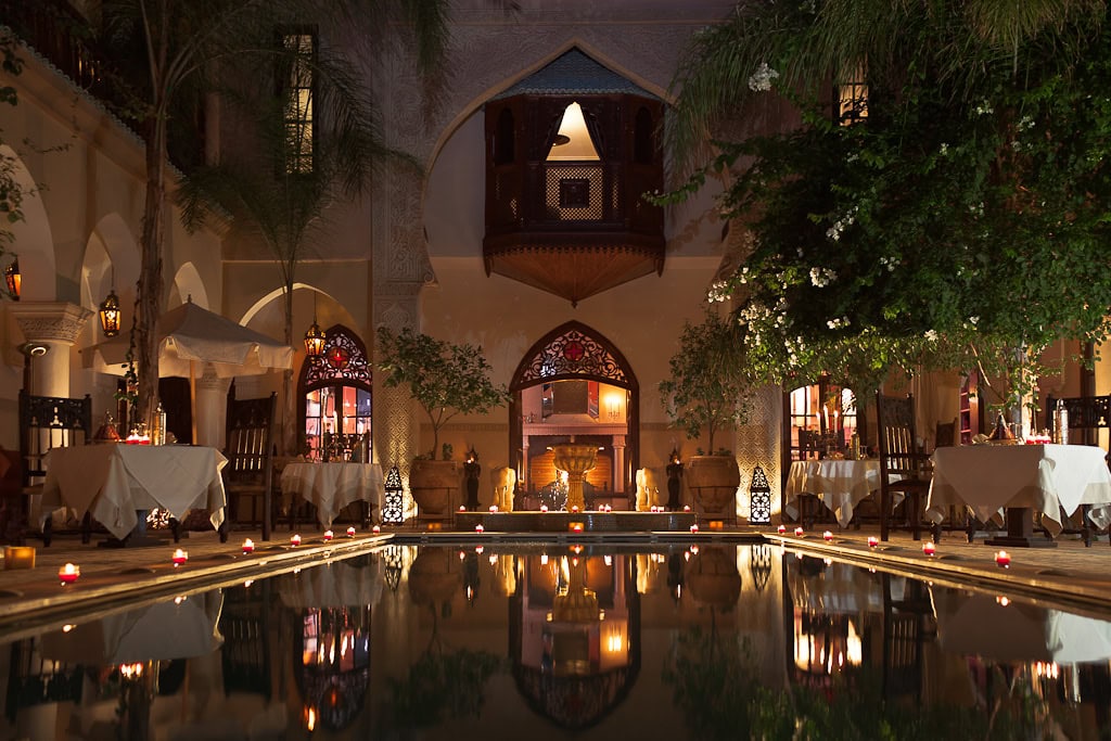 Stimmungsvolle Abendatmosphäre im Riad Demeures d’Orient in Marrakesch mit beleuchtetem Innenhof und Pool.